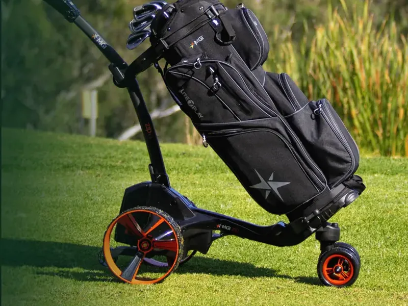 Electric golf buggy carrying a golf bag on the fairway