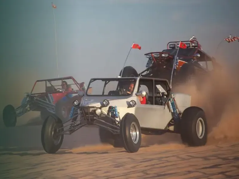 Dune buggies driving across sand